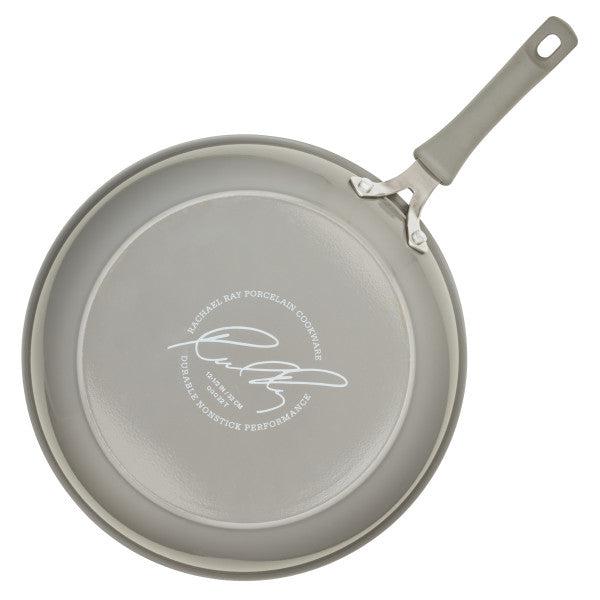 The Cook + Create Nonstick Frying Pan in gray, made from thicker gauge aluminum and featuring a signature on the bottom, offers a high-performance cooking experience.