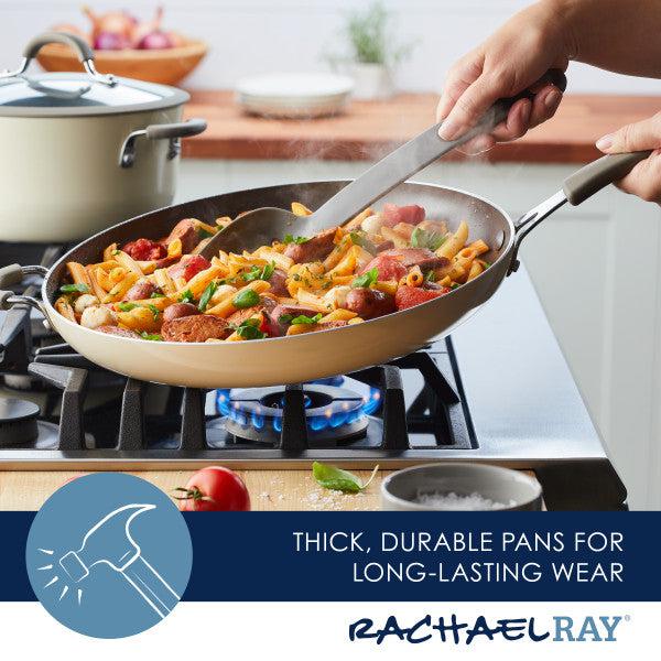 A person is expertly cooking pasta in a Cook + Create Nonstick Frying Pan on a gas stove.