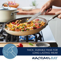 A person is expertly cooking pasta in a Cook + Create Nonstick Frying Pan on a gas stove.