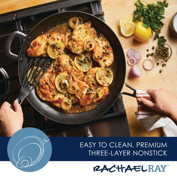 A person is whipping up lemon chicken with herbs and onions using the Cook + Create Hard Anodized Nonstick Frying Pan, taking advantage of its robust hard-anodized aluminum for uniform heat distribution. The nonstick surface allows for easy food release and hassle-free cleanup.