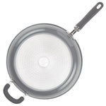 Top view of a nonstick frying pan with a black handle on a white background.