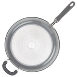 Top view of a nonstick frying pan with a black handle on a white background.