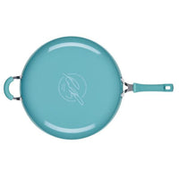 Cook + Create Nonstick Frying Pan in teal, designed with a thicker gauge aluminum for enhanced durability and featuring a handle, shown from an aerial perspective.
