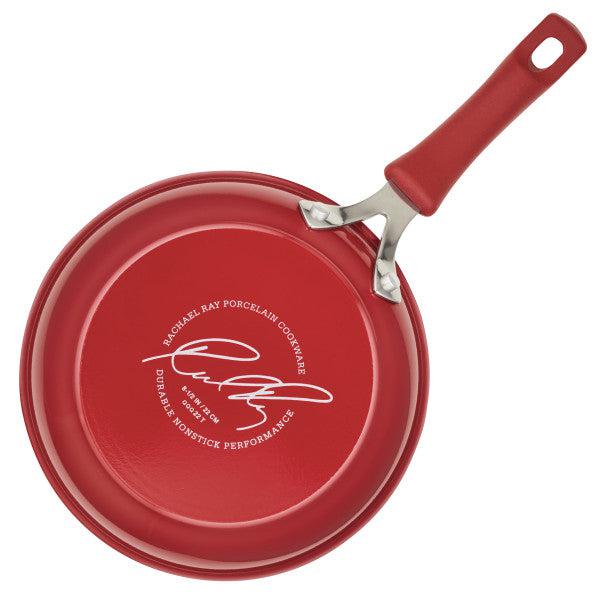 Cook + Create Nonstick Frying Pan crafted from thicker gauge aluminum, featuring an autograph and a high-performance nonstick label on the bottom.