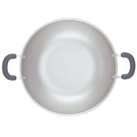 Empty cooking pot with two black handles, viewed from above.