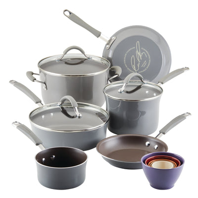 Gray cookware set including pots, pans, and colorful measuring bowls.