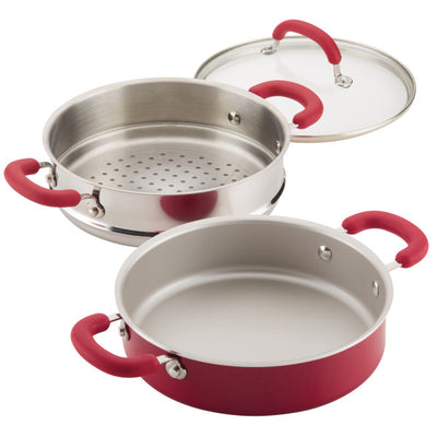 Red-handled steamer pot set with glass lid and stainless steel insert.