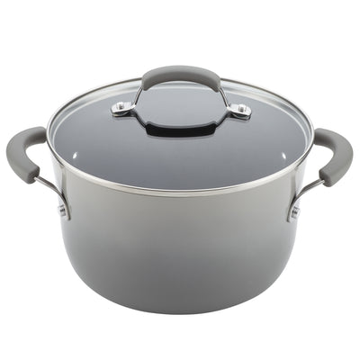 A gray cooking pot with a glass lid and black handles.