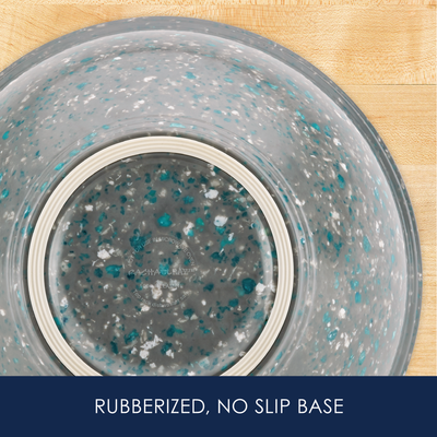 Bottom of a bowl with a rubberized, non-slip base on a wooden surface.