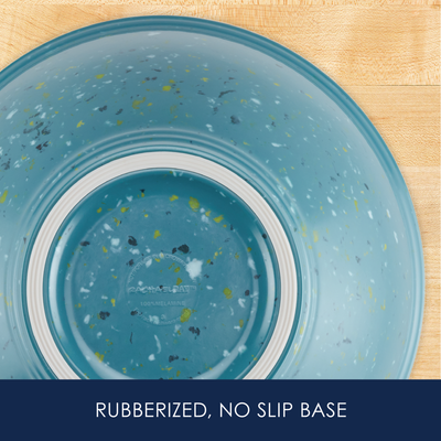 A speckled blue bowl with a rubberized, no-slip base on a wood surface.