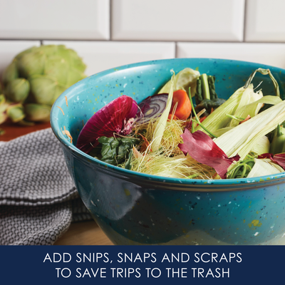 Bowl of vegetable scraps in a kitchen setting.