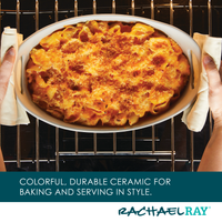 Hands holding a baked pasta dish being placed in the oven.