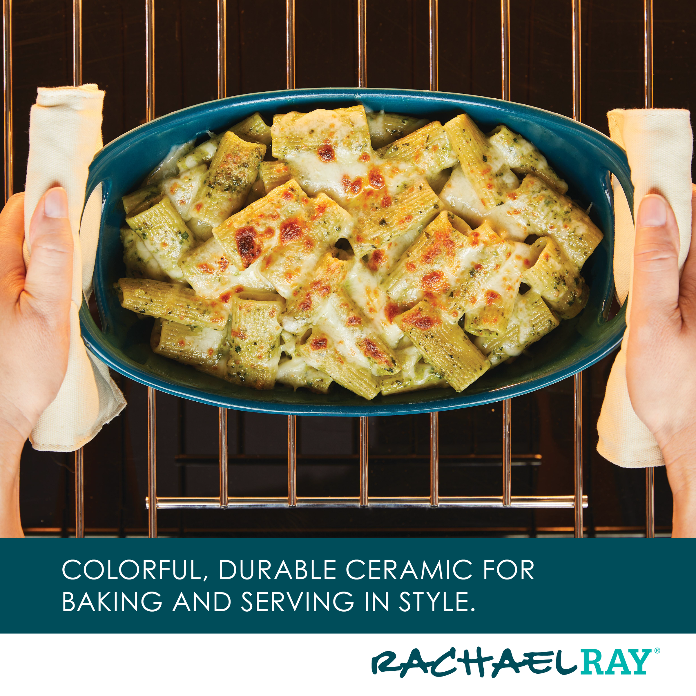 Hands placing a ceramic dish with baked pasta into an oven.