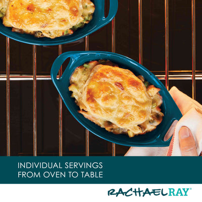 Two baked dishes in blue ramekins on an oven rack, hand holding a towel.
