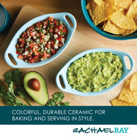 Ceramic dishes with salsa and guacamole, chips, and an avocado on a board.