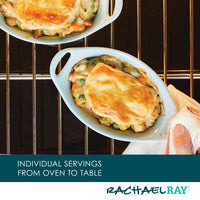 Two small casseroles with golden crusts on an oven rack.