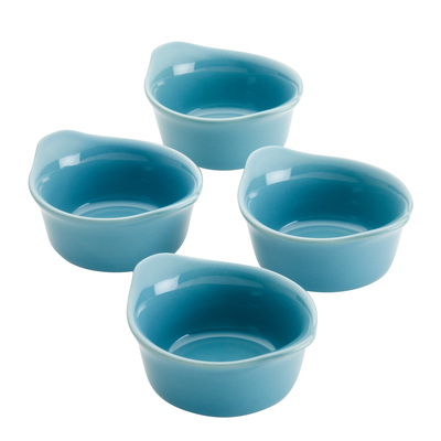 Four small blue ceramic bowls with pouring spouts arranged in a group.