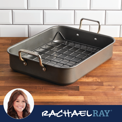 A roasting pan on a wooden countertop with white tiled backsplash.