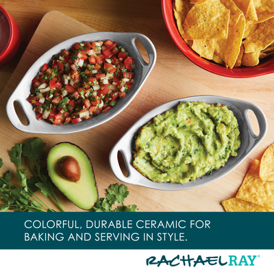 Ceramic dishes with salsa and guacamole, surrounded by chips and an avocado.