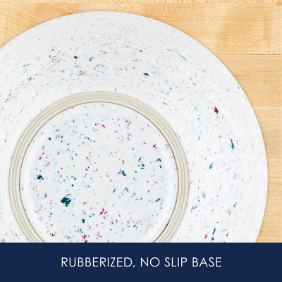 Speckled bowl with rubberized, non-slip base on a wooden surface.