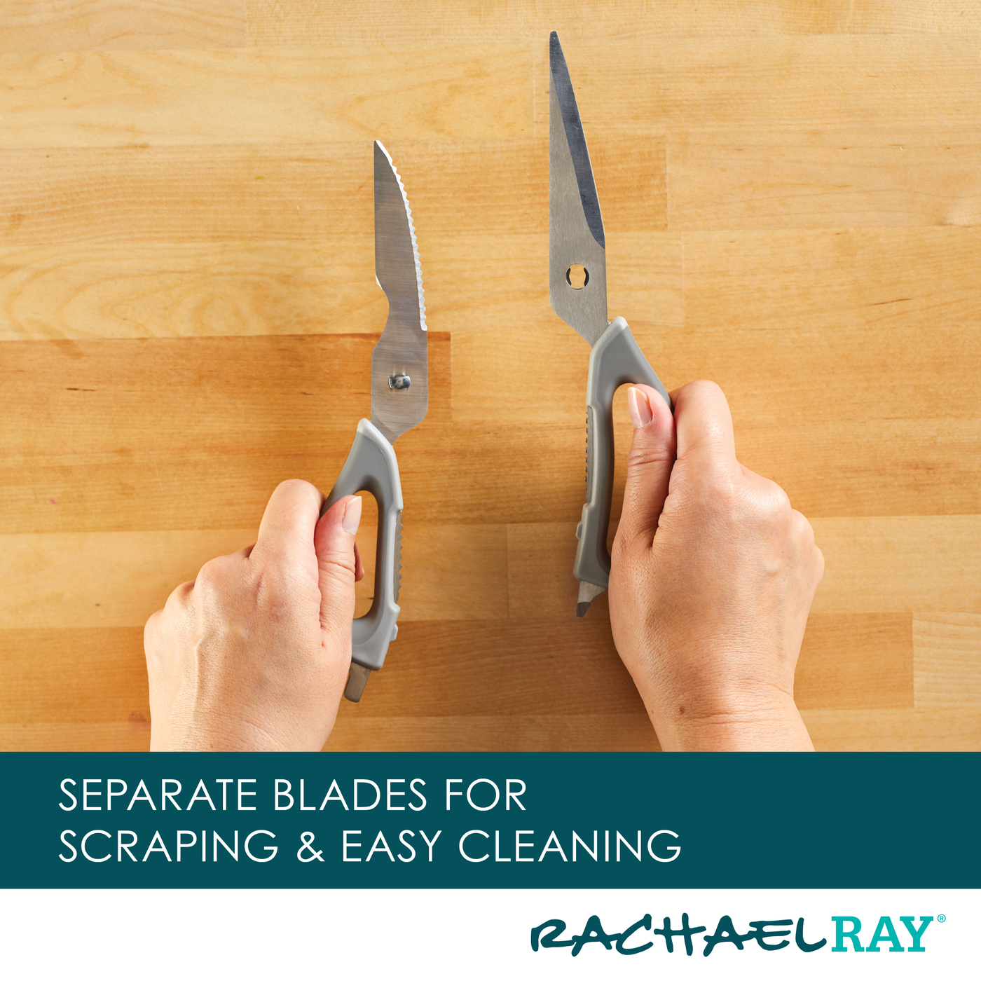 Hands holding kitchen shears with separate blades on a wooden surface.