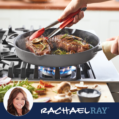 Grilling steaks in a pan with herbs and garlic on a stovetop.