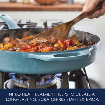 A skillet on a stove with food being stirred by a wooden spoon.