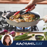 Chicken and onions cooking in a pan on a stovetop flame.