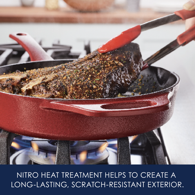 Cooking seasoned meat in a red pan on a gas stove.