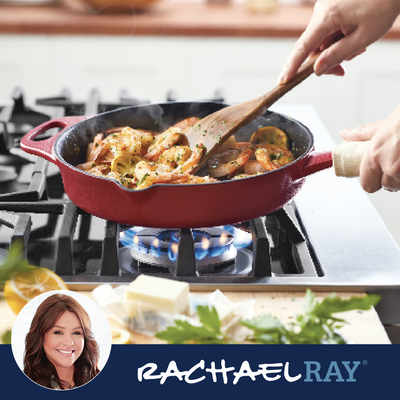 Person stirring shrimp in a red pan on a stovetop flame.