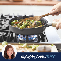 Person stirring brussels sprouts in a skillet on a gas stove.