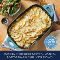 Baked potato dish in a blue baking pan with salad on the side.