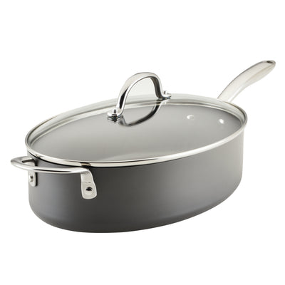 A covered, oval-shaped nonstick saucepan with a handle and glass lid.