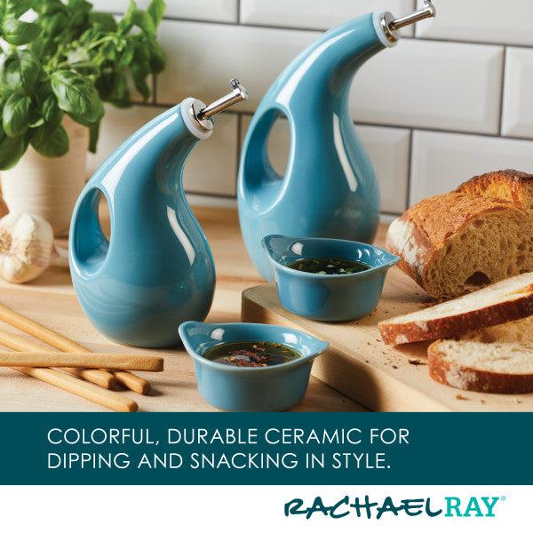 The EVOO Bottle and Ramekin Dipper Set sits gracefully on the table alongside fresh bread and herbs. This charming ceramic set is not only stylish but also dishwasher safe, making cleanup a breeze.