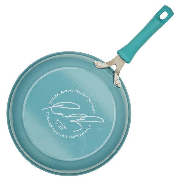 Experience exceptional cooking with the turquoise Cook + Create Nonstick Frying Pan, designed from thicker gauge aluminum, showcasing a signature bottom and a striking teal handle.