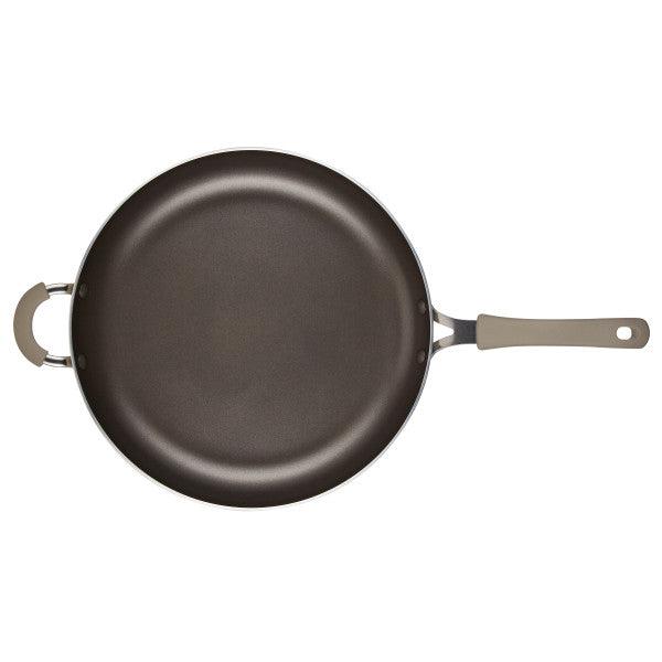A Cook + Create Nonstick Frying Pan featuring a gray handle and helper handle, made from thicker gauge aluminum for enhanced durability.