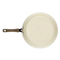 Cook + Create nonstick frying pan in cream with a brown handle, made from thicker gauge aluminum, viewed from above for optimal cooking performance.