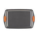 Non-stick baking tray with orange silicone handles.