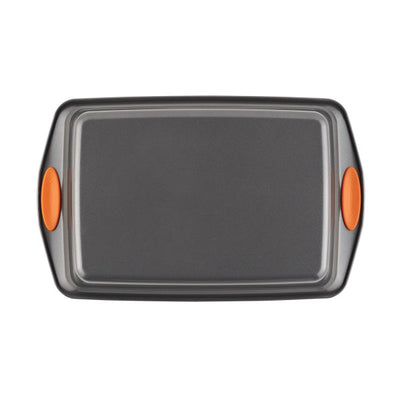 Non-stick baking tray with orange silicone handles.