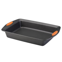 The 9-Inch x 13-Inch Nonstick Rectangle Roasting & Cake Pan includes vibrant orange handle grips on each side and is made from heavy gauge steel for durability and oven safety.