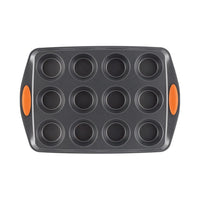 The 12-Cup Nonstick Cupcake & Muffin Pan is designed with twelve circular cups and features orange handles. It's made from heavy gauge steel, ensuring durability and even baking.