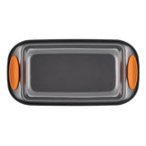 A rectangular baking tray with orange silicone handles, viewed from above.