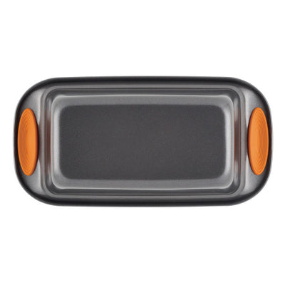 A rectangular baking tray with orange silicone handles, viewed from above.