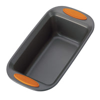 The 9-Inch x 5-Inch Nonstick Loaf/Meatloaf Pan, featuring gray nonstick coating and orange silicone grips on the handles, is crafted from heavy gauge steel. It's oven safe, ensuring easy baking and perfect results every time.