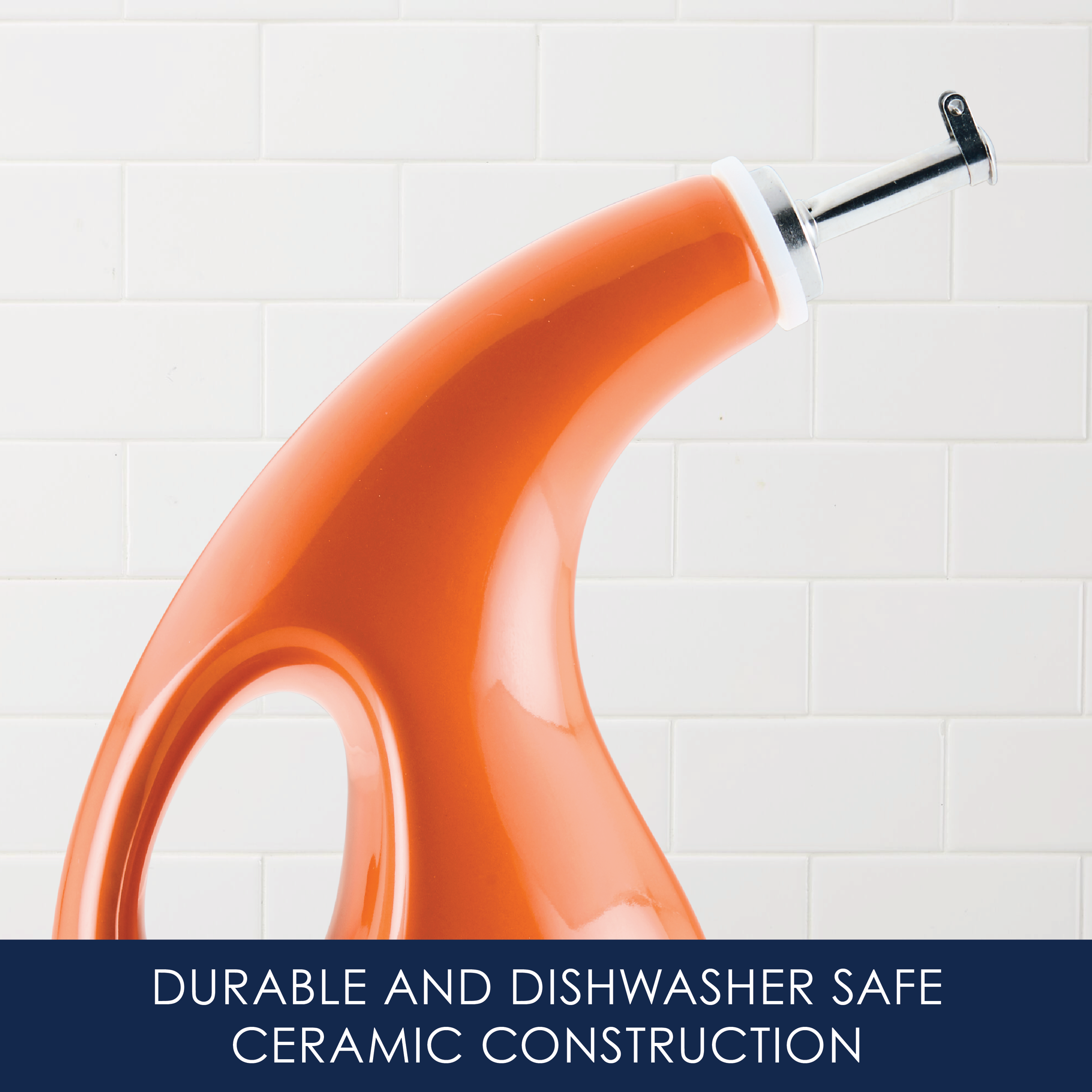Orange ceramic oil dispenser with a spout, against a tiled wall background.