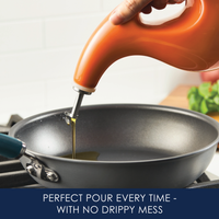 Pouring oil into a frying pan from a spill-resistant bottle.