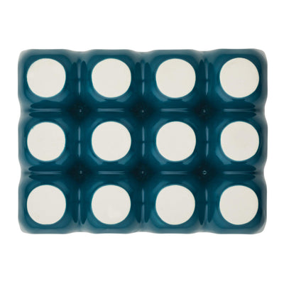 Overhead view of a blue ice cube tray with white circular sections.