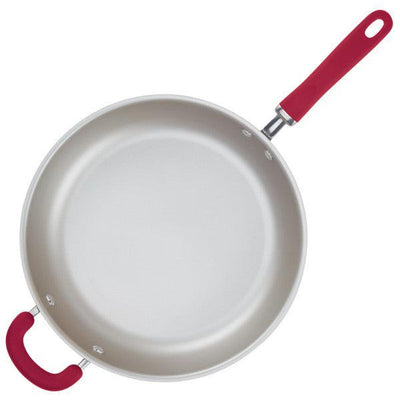 Non-stick frying pan with red handles on a white background.