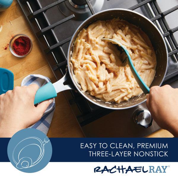 A person is stirring pasta in a 3-Quart Cook + Create Nonstick Saucier Pan on a stovetop using a blue spatula, reminiscent of scenes from the Food Network.