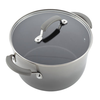 Gray cooking pot with a glass lid and rubberized handles.